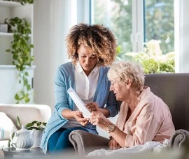 Home Care Specialist taking care of senior woman. 